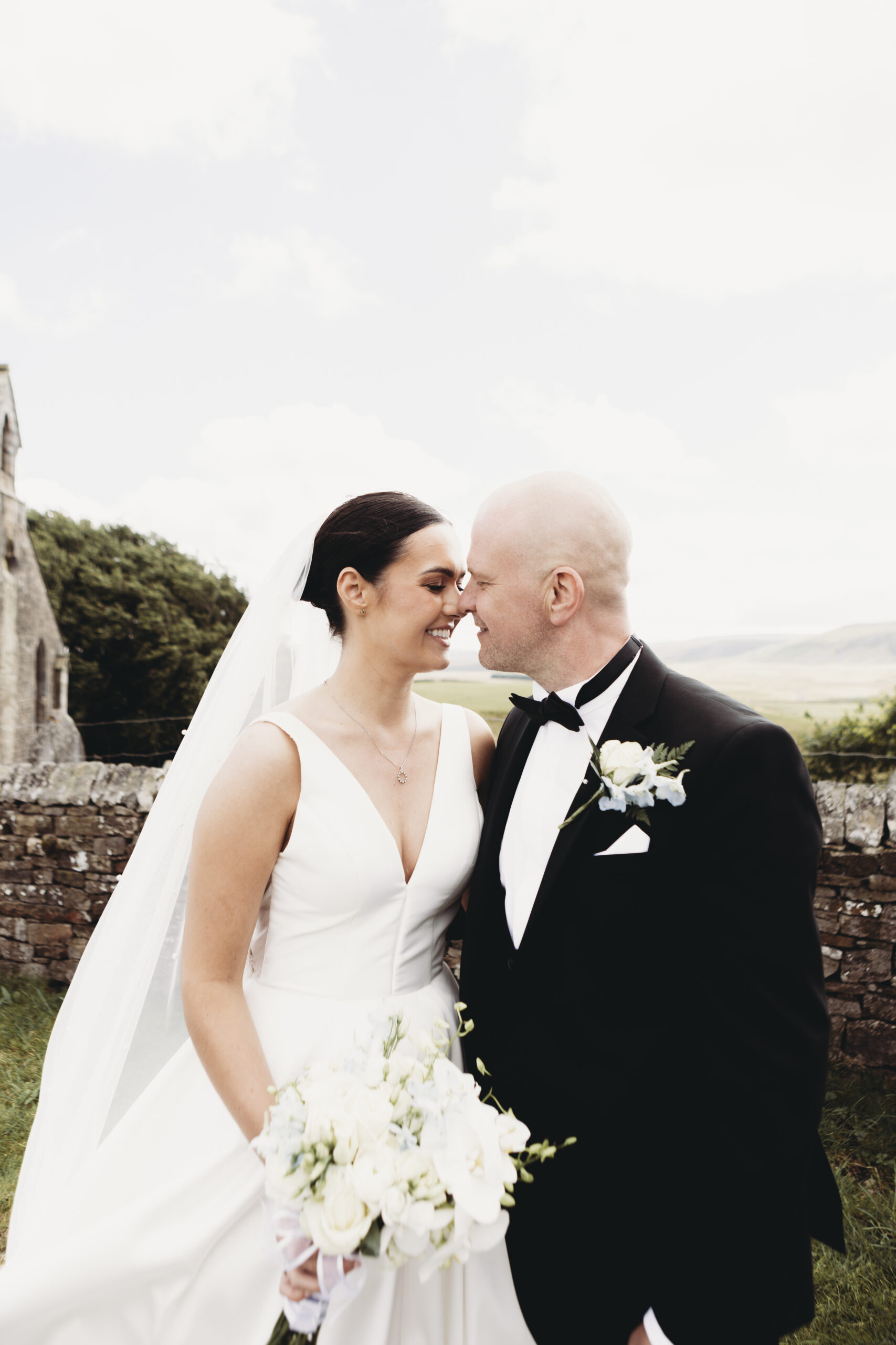 bride and groom in bishop auckland church the beaumont hexham wedding. Wedding dress and groom tuxedo suit