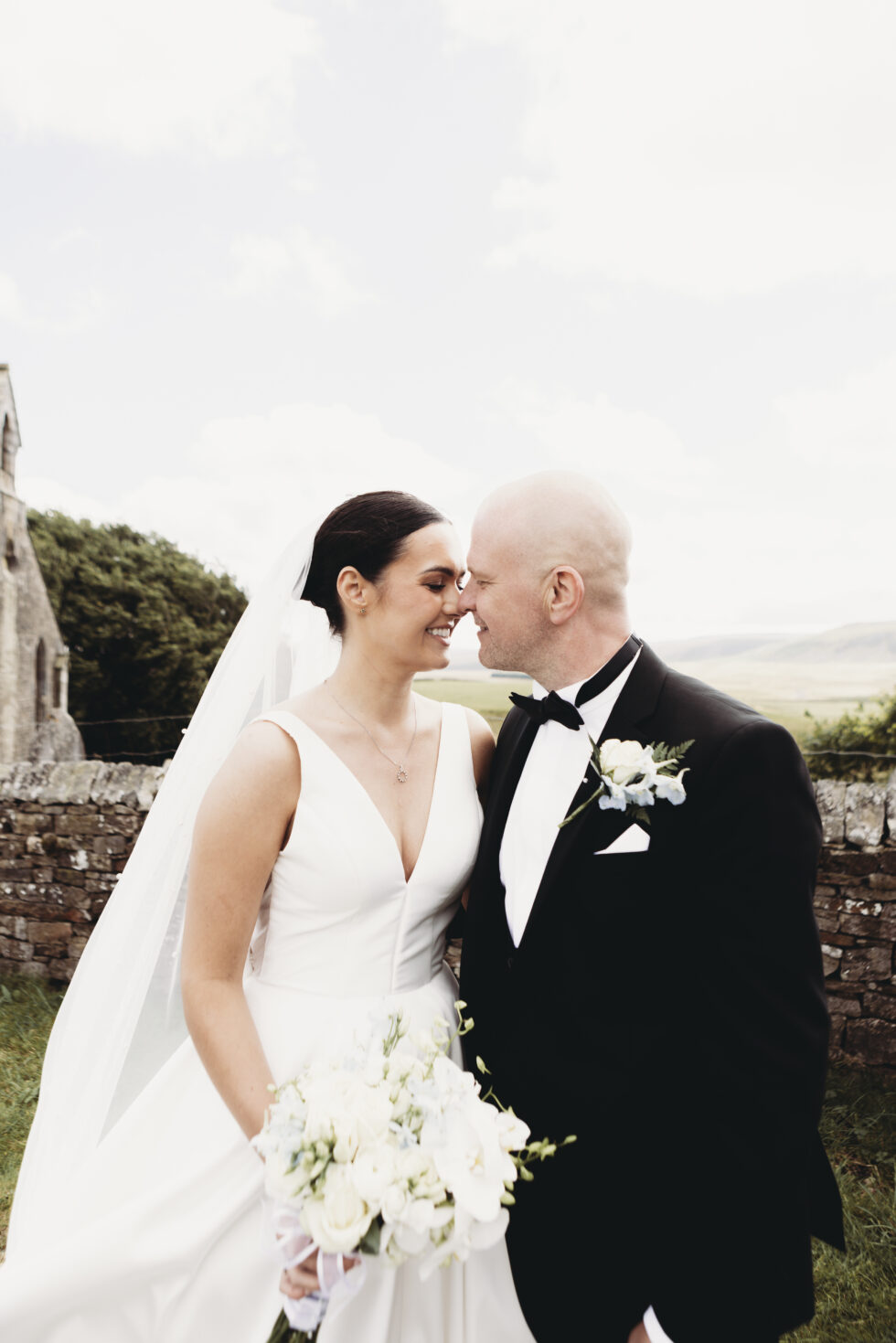 bride and groom in bishop auckland church the beaumont hexham wedding. Wedding dress and groom tuxedo suit