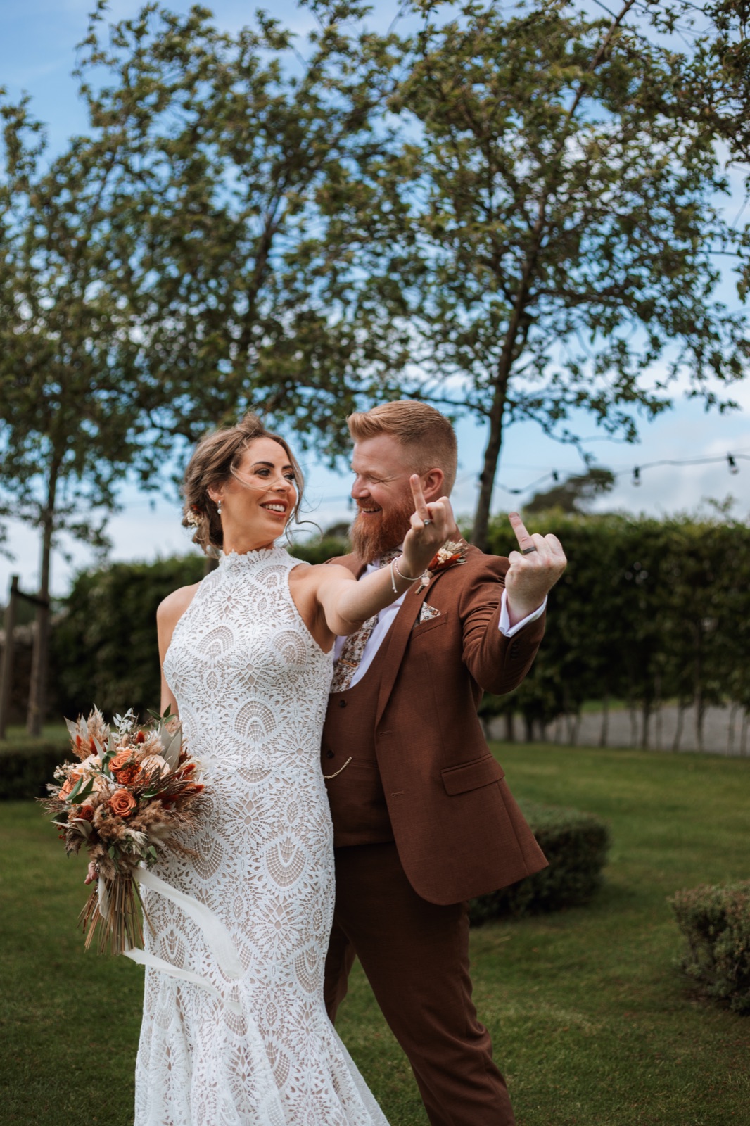 Newlyweds laughing and showing off their wedding rings